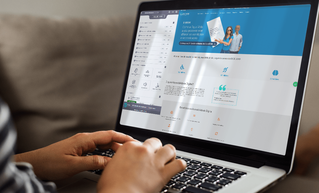 Epilepsia. Imagem de uma mão branca digitando no notebook. O notebook está aberto no site da EqualWeb.