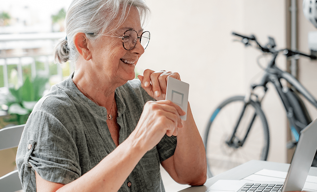 Acessíveis. Imagem de uma senhora de idade de cabelos grisalhos usado óculos e sorrindo .
